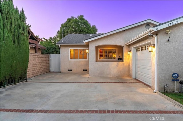 13837 Sylvan St, Valley Glen, CA 91401 - view of front facade with stucco siding, a garage, driveway, and crawl space