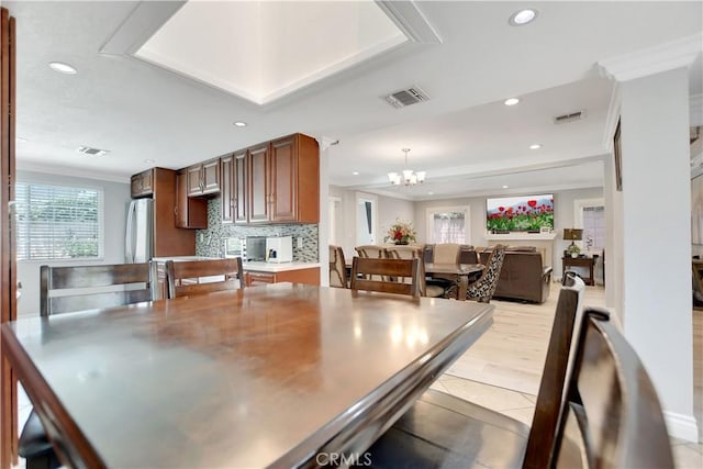 1305 E Eckerman Ave, West Covina, CA 91790 - dining space with recessed lighting, a chandelier, ornamental molding, light tile patterned flooring, and a raised ceiling