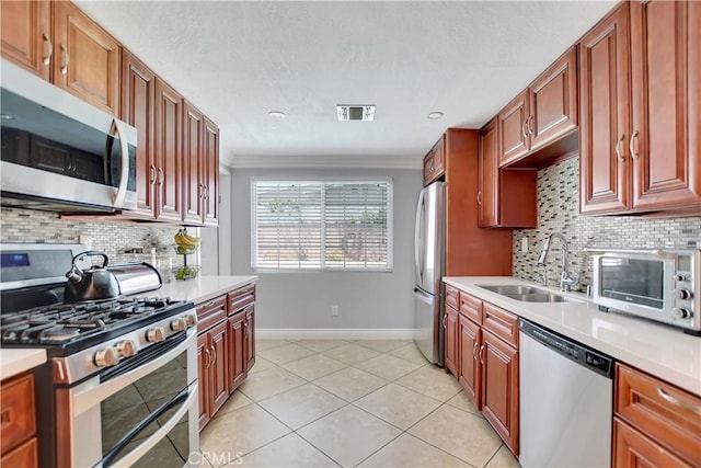 1305 E Eckerman Ave, West Covina, CA 91790 - kitchen with stainless steel appliances, light countertops, tasteful backsplash, and crown molding