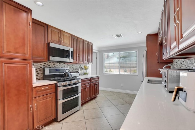 1305 E Eckerman Ave, West Covina, CA 91790 - kitchen with appliances with stainless steel finishes, light countertops, decorative backsplash, crown molding, and light tile patterned flooring