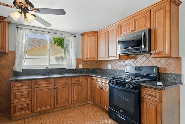 10288 Effen St, Rancho Cucamonga, CA 91730 - kitchen with stainless steel microwave, black range with gas stovetop, ceiling fan, brown cabinetry, and tasteful backsplash