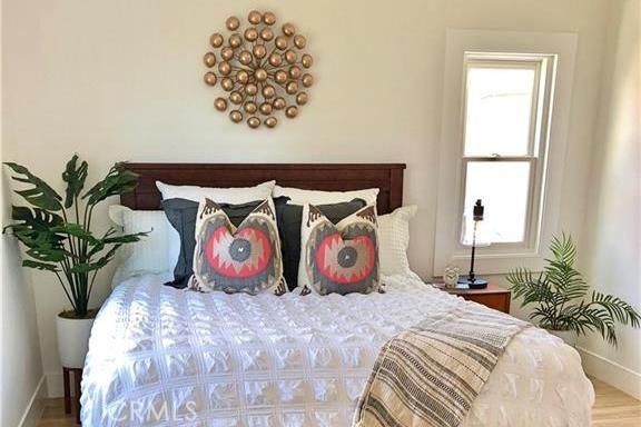 341 W Whiting Ave, Fullerton, CA 92832 - bedroom featuring multiple windows and wood finished floors