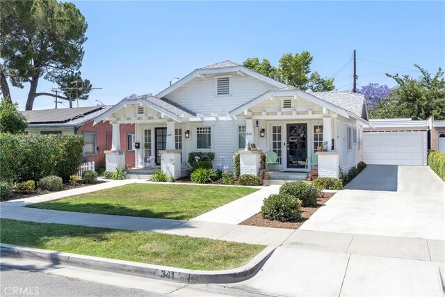 341 W Whiting Ave, Fullerton, CA 92832 - bungalow-style home featuring a front yard, covered porch, and a detached garage