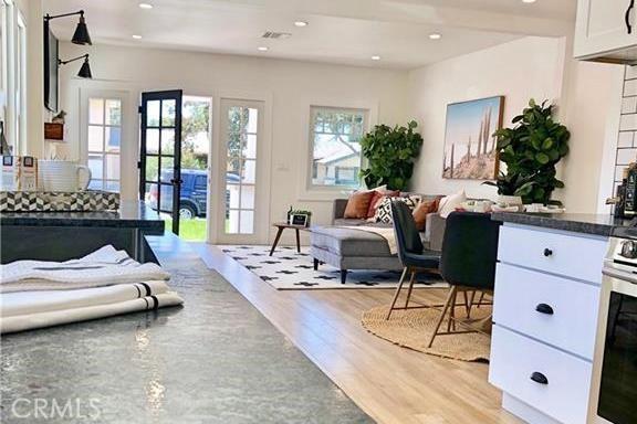 341 W Whiting Ave, Fullerton, CA 92832 - bedroom featuring light wood-style flooring, multiple windows, access to outside, and recessed lighting