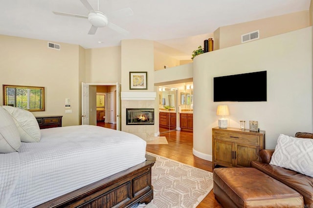 282 Camino Del Postigo, Escondido, CA 92029 - bedroom with wood finished floors, a tile fireplace, ceiling fan, and a towering ceiling