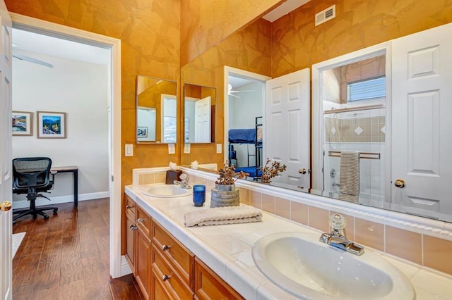 282 Camino Del Postigo, Escondido, CA 92029 - bathroom featuring wood finished floors, double vanity, a stall shower, and a ceiling fan