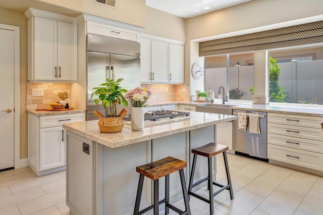 282 Camino Del Postigo, Escondido, CA 92029 - kitchen featuring stainless steel appliances, white cabinetry, a breakfast bar, and recessed lighting