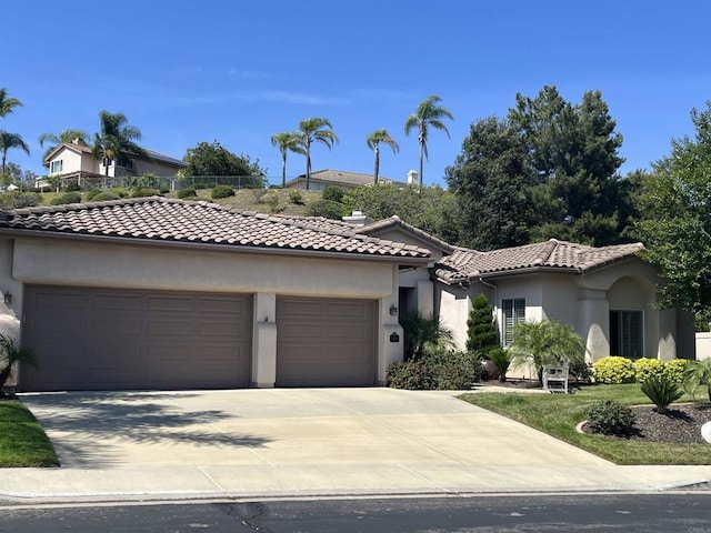282 Camino Del Postigo, Escondido, CA 92029 - mediterranean / spanish house with an attached garage, stucco siding, a tiled roof, and concrete driveway