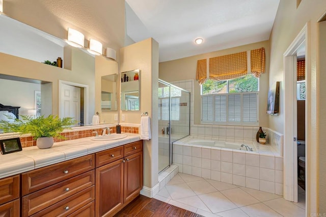 282 Camino Del Postigo, Escondido, CA 92029 - full bath with a garden tub, vanity, a stall shower, wood finished floors, and tasteful backsplash