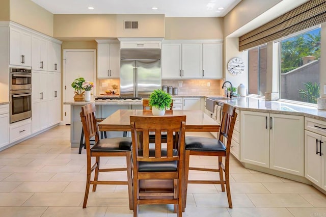 282 Camino Del Postigo, Escondido, CA 92029 - kitchen with stainless steel appliances, decorative backsplash, white cabinets, and recessed lighting