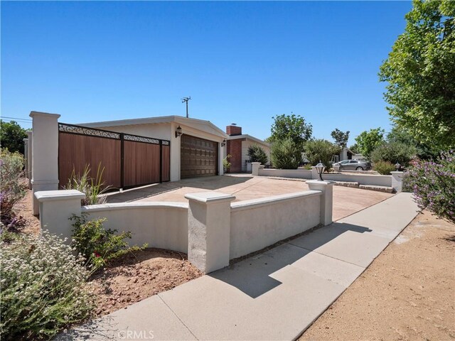 27545 Santa Clarita Rd, Saugus, CA 91350 - view of home's exterior featuring a fenced front yard, a garage, and driveway