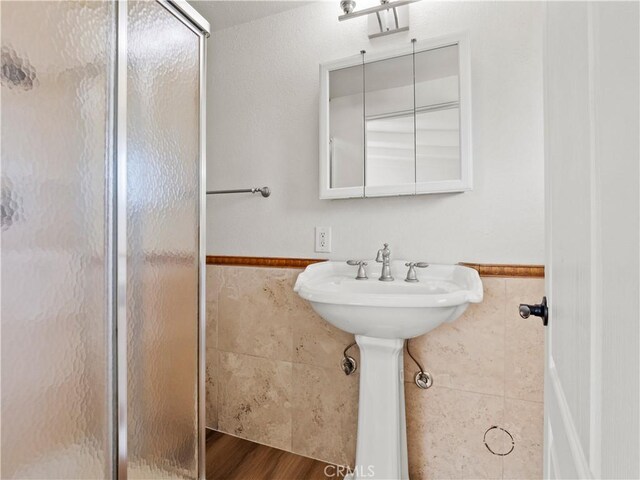 27545 Santa Clarita Rd, Saugus, CA 91350 - full bath featuring tile walls, a shower stall, and wainscoting