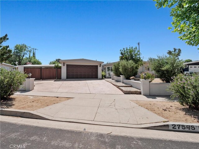 27545 Santa Clarita Rd, Saugus, CA 91350 - view of front of house featuring driveway, a garage, and stucco siding