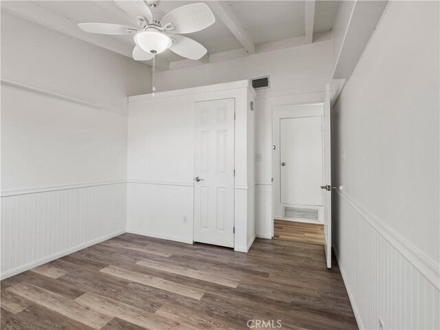 27545 Santa Clarita Rd, Saugus, CA 91350 - unfurnished bedroom with beam ceiling, wood finished floors, wainscoting, and a ceiling fan