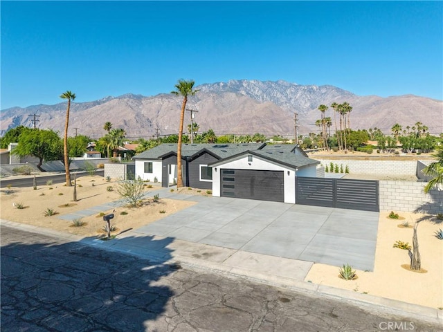 2901 N Biskra Rd, Palm Springs, CA 92262 - view of front facade featuring a mountain view, an attached garage, and driveway
