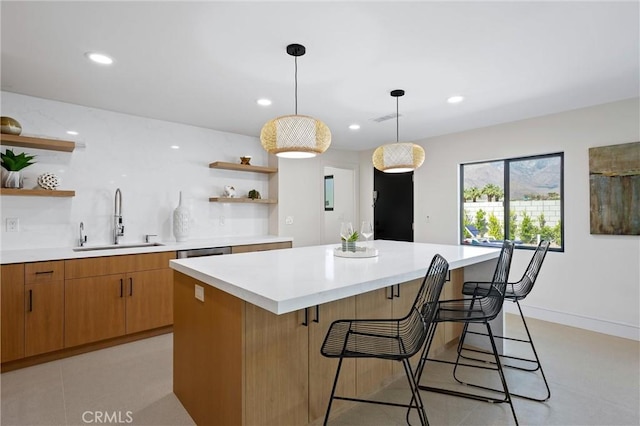 2901 N Biskra Rd, Palm Springs, CA 92262 - kitchen featuring open shelves, light countertops, a center island, a breakfast bar area, and recessed lighting