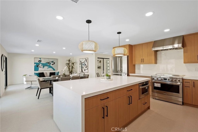 2901 N Biskra Rd, Palm Springs, CA 92262 - kitchen with appliances with stainless steel finishes, wall chimney exhaust hood, light countertops, decorative light fixtures, and recessed lighting