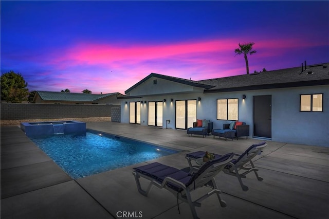 2901 N Biskra Rd, Palm Springs, CA 92262 - pool at dusk with a patio area, a pool with connected hot tub, and a fenced backyard