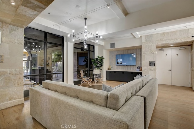 24545 Town Center Dr Unit 5405, Valencia, CA 91355 - living room featuring wood finished floors, a chandelier, and beamed ceiling