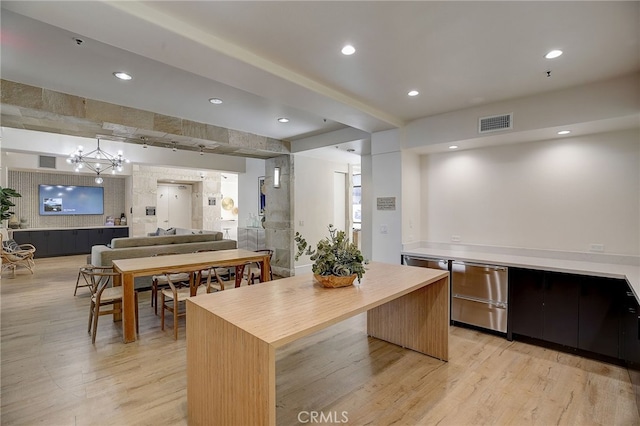 24545 Town Center Dr Unit 5405, Valencia, CA 91355 - kitchen with light wood-type flooring, open floor plan, wood counters, a chandelier, and a center island
