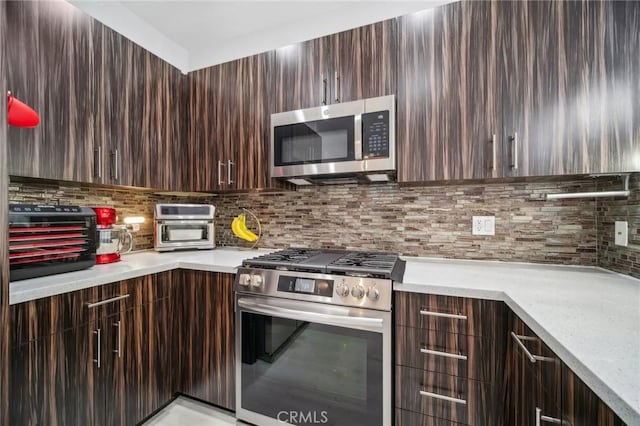 24545 Town Center Dr Unit 5405, Valencia, CA 91355 - kitchen with appliances with stainless steel finishes, modern cabinets, and light countertops
