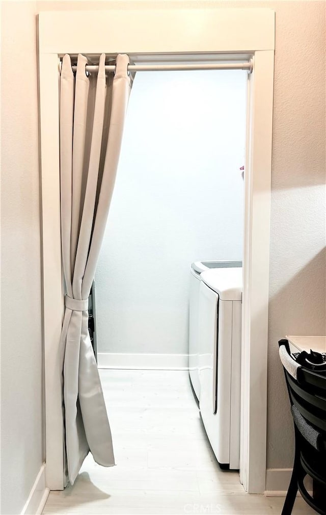 24545 Town Center Dr Unit 5405, Valencia, CA 91355 - laundry area with baseboards and light wood-type flooring