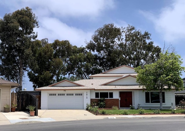 1878 Wolviston Way, San Diego, CA 92154 - view of front of home featuring a garage, concrete driveway, brick siding, and a shingled roof