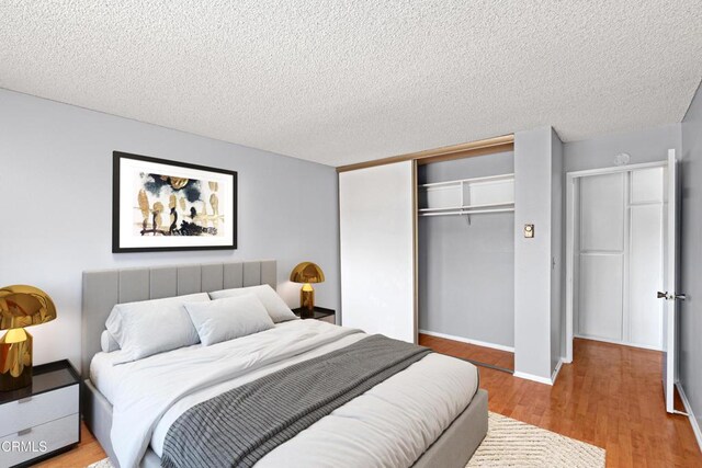 5870 Benner St Unit 102, Los Angeles, CA 90042 - bedroom with a closet, wood finished floors, and a textured ceiling