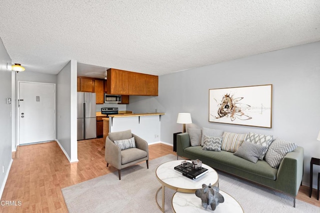 5870 Benner St Unit 102, Los Angeles, CA 90042 - living area with light wood finished floors and a textured ceiling