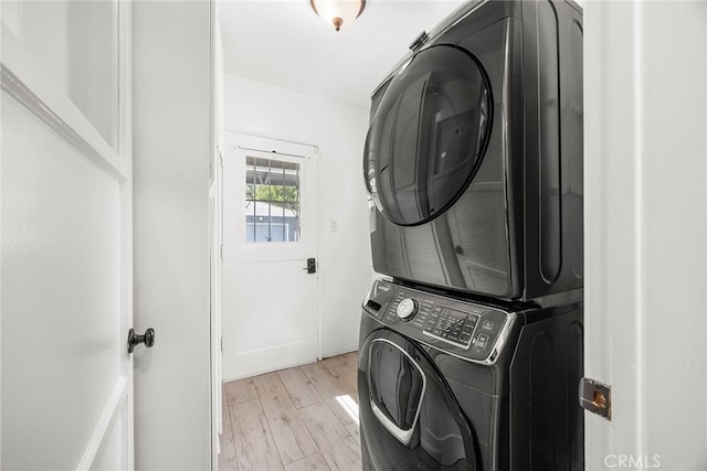 17139 Strathern St, Van Nuys, CA 91406 - laundry area featuring stacked washer / dryer and light wood-type flooring