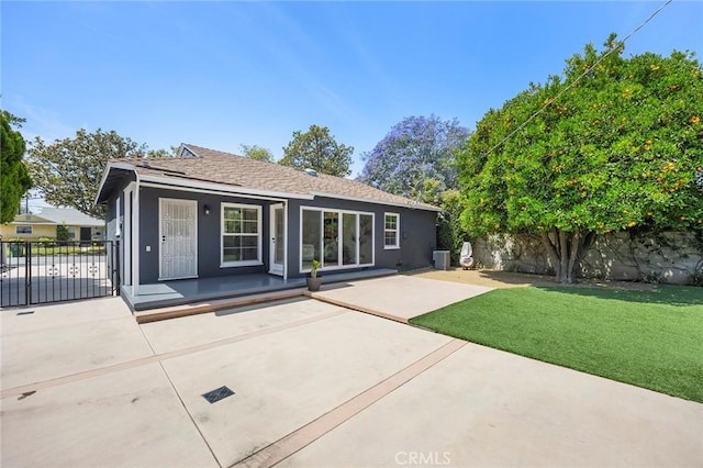 17139 Strathern St, Van Nuys, CA 91406 - rear view of house featuring a patio area, stucco siding, and roof with shingles