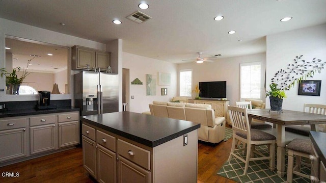 1239 Bayside Ln, Oxnard, CA 93035 - kitchen with stainless steel fridge with ice dispenser, dark countertops, ceiling fan, a kitchen island, and dark wood-type flooring