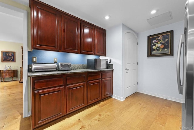 301 W G St Unit 119, San Diego, CA 92101 - kitchen featuring reddish brown cabinets, light wood finished floors, stainless steel refrigerator, and recessed lighting