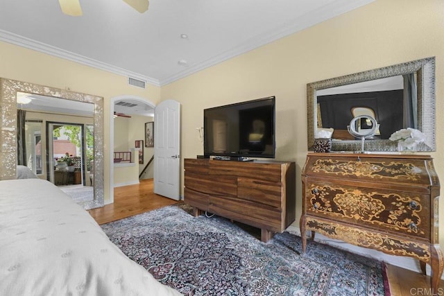 301 W G St Unit 119, San Diego, CA 92101 - bedroom with ornamental molding, wood finished floors, arched walkways, and a ceiling fan