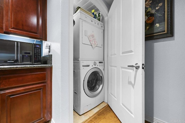 301 W G St Unit 119, San Diego, CA 92101 - laundry room with estacked washer and dryer and light tile patterned floors