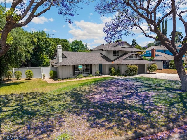 1345 W Valley View Dr, Fullerton, CA 92833 - traditional-style house featuring a chimney, driveway, an attached garage, board and batten siding, and a shingled roof