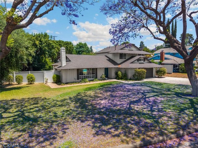 1345 W Valley View Dr, Fullerton, CA 92833 - traditional home with a chimney, driveway, an attached garage, board and batten siding, and roof with shingles