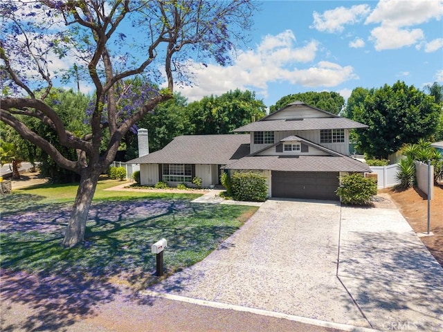 1345 W Valley View Dr, Fullerton, CA 92833 - view of front of property featuring a garage, a chimney, driveway, a shingled roof, and board and batten siding
