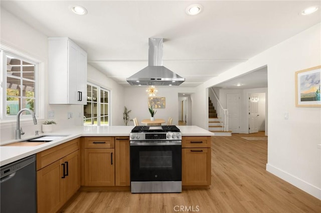 1345 W Valley View Dr, Fullerton, CA 92833 - kitchen featuring exhaust hood, stainless steel gas range oven, dishwashing machine, a peninsula, and light countertops