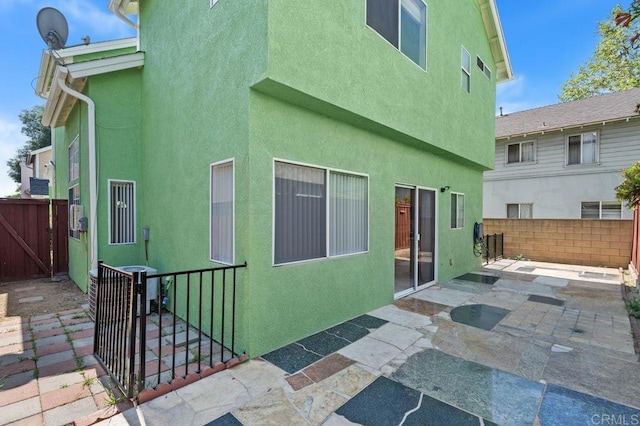 15140 Chase St, North Hills, CA 91343 - back of property featuring a gate, stucco siding, and a patio area