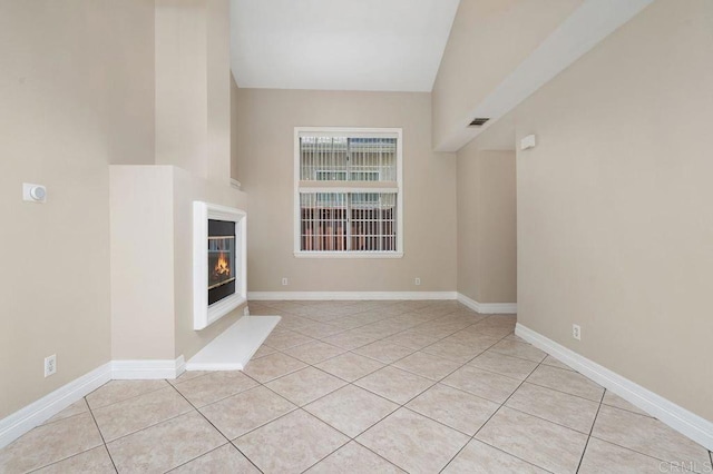 15140 Chase St, North Hills, CA 91343 - unfurnished living room with a glass covered fireplace, tile patterned floors, and high vaulted ceiling