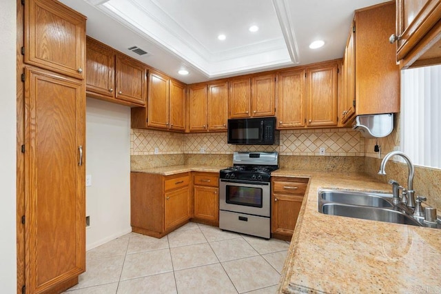 15140 Chase St, North Hills, CA 91343 - kitchen with stainless steel range with gas stovetop, black microwave, brown cabinets, backsplash, and recessed lighting