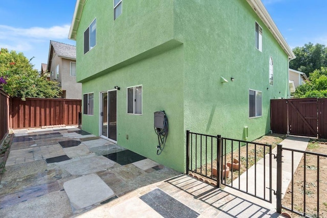 15140 Chase St, North Hills, CA 91343 - rear view of property with a gate, a patio, a fenced backyard, and stucco siding