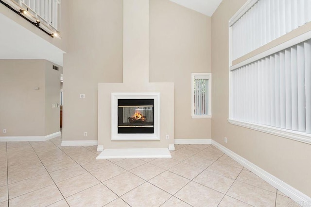 15140 Chase St, North Hills, CA 91343 - unfurnished living room with a high ceiling, light tile patterned floors, and a multi sided fireplace