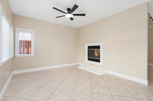 15140 Chase St, North Hills, CA 91343 - unfurnished living room featuring ceiling fan, light tile patterned floors, and a glass covered fireplace