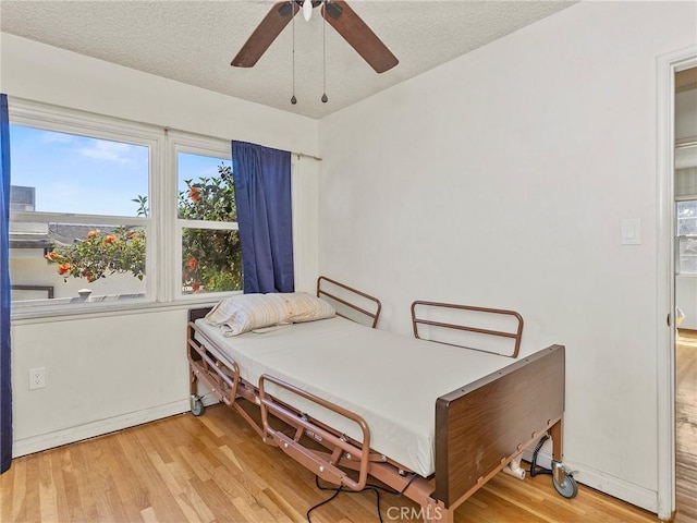 2724 Scott Rd, Burbank, CA 91504 - bedroom featuring wood finished floors, a textured ceiling, and ceiling fan