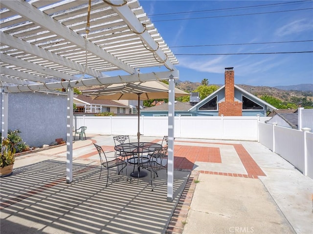 2724 Scott Rd, Burbank, CA 91504 - fenced backyard featuring a mountain view, a pergola, a patio, and outdoor dining space