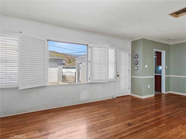 2724 Scott Rd, Burbank, CA 91504 - empty room featuring wood finished floors, a textured ceiling, and crown molding