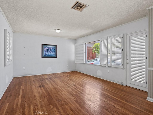 2724 Scott Rd, Burbank, CA 91504 - spare room featuring a textured ceiling, wood finished floors, and ornamental molding
