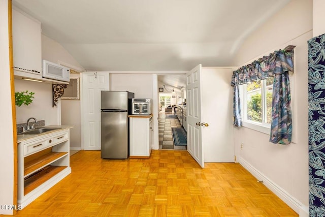 216 N Fulton St, Ojai, CA 93023 - kitchen featuring freestanding refrigerator, lofted ceiling, white microwave, open shelves, and heating unit